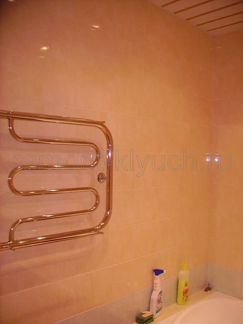 Облицовка стен ванной комнаты керамическими плитками с затиркой швов, устройство бордюра, установка полотенцесушителя 